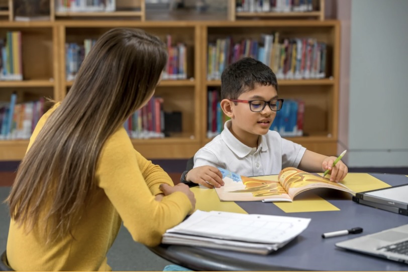 Teacher helping student